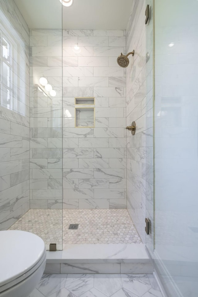 bathroom with an enclosed shower and toilet