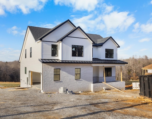 modern inspired farmhouse with a garage