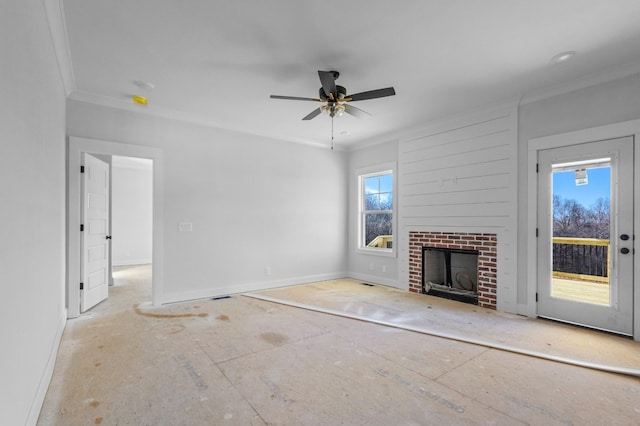 unfurnished living room featuring a brick fireplace, crown molding, and ceiling fan