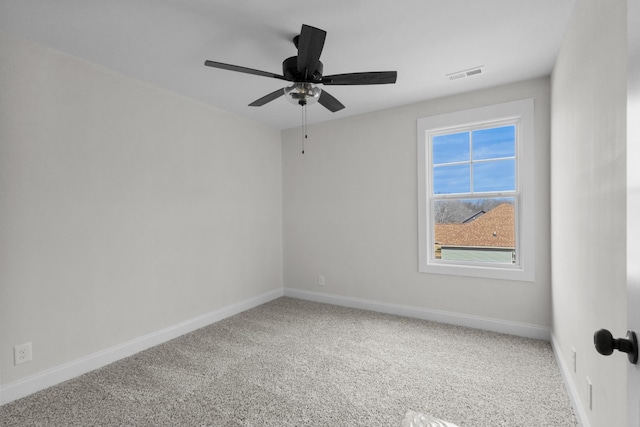 carpeted empty room featuring visible vents, ceiling fan, and baseboards