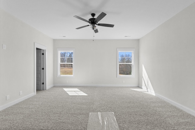 spare room featuring baseboards, carpet, and a healthy amount of sunlight