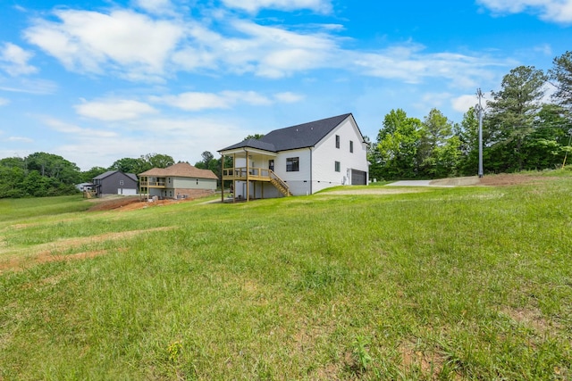 983 Palmyra Rd, Clarksville, TN 37040 - view of grassy yard with a garage, a wooden deck, stairs, and driveway