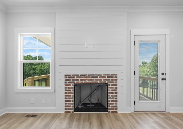 983 Palmyra Rd, Clarksville, TN 37040 - unfurnished living room with crown molding, light wood-type flooring, a fireplace, and baseboards