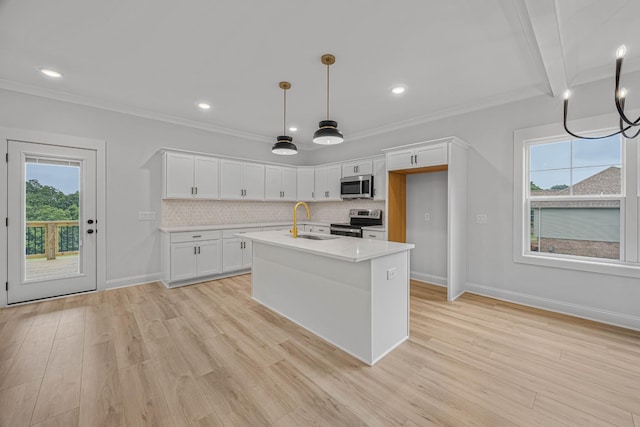 983 Palmyra Rd, Clarksville, TN 37040 - kitchen featuring appliances with stainless steel finishes, a sink, light countertops, white cabinets, and light wood-style flooring
