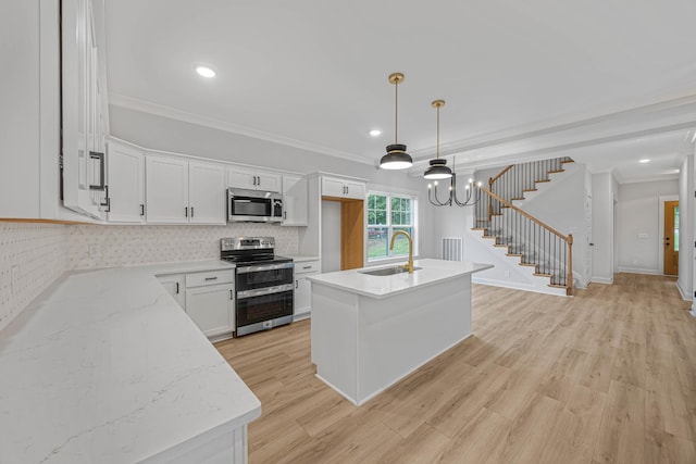 983 Palmyra Rd, Clarksville, TN 37040 - kitchen with appliances with stainless steel finishes, a sink, white cabinetry, light wood-style flooring, and recessed lighting