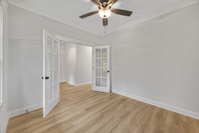 983 Palmyra Rd, Clarksville, TN 37040 - spare room with french doors, baseboards, light wood-style floors, a ceiling fan, and crown molding