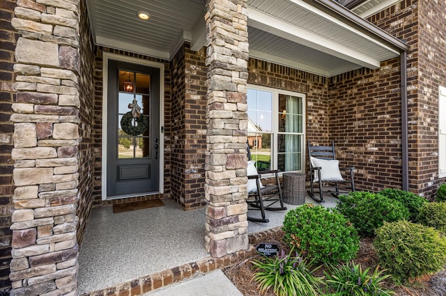 view of exterior entry with a porch