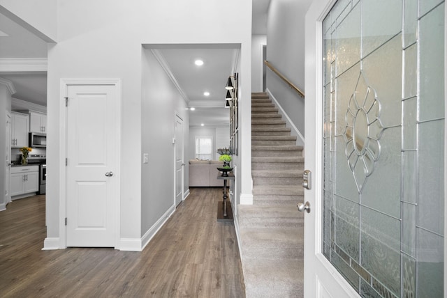 foyer with dark hardwood / wood-style floors and ornamental molding