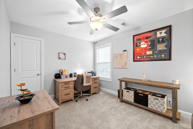 carpeted office space featuring ceiling fan