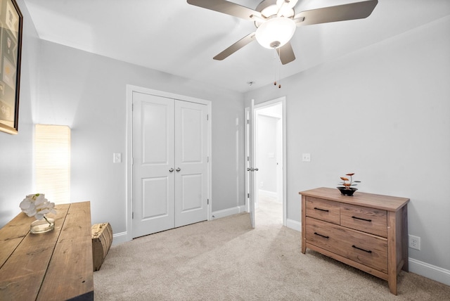 carpeted bedroom with a closet and ceiling fan