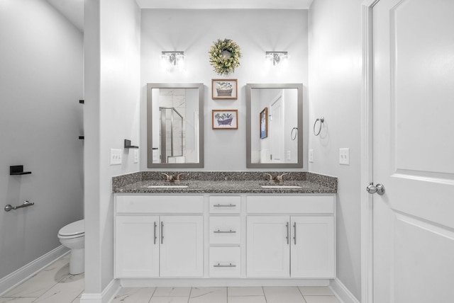 bathroom with a shower, vanity, and toilet