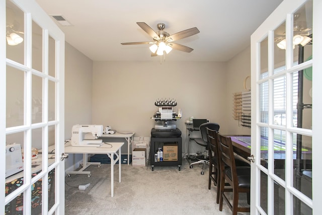 carpeted home office featuring ceiling fan