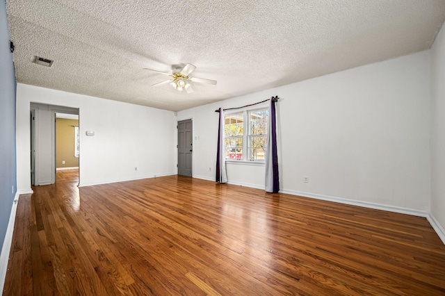 spare room with ceiling fan, hardwood / wood-style floors, and a textured ceiling