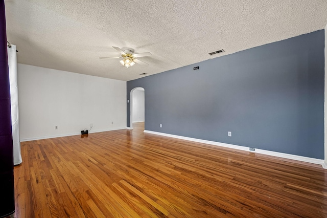 unfurnished room featuring wood-type flooring, a textured ceiling, and ceiling fan