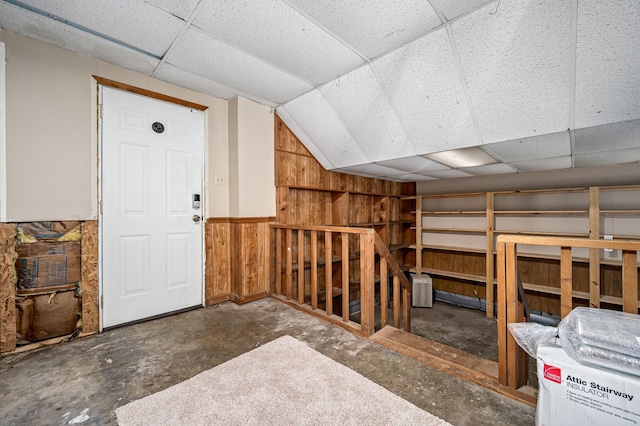 additional living space with lofted ceiling and wooden walls