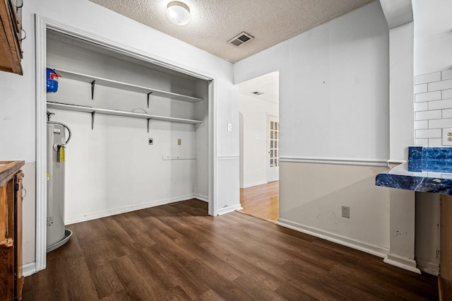 interior space with dark hardwood / wood-style floors and a textured ceiling