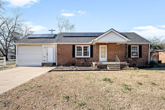 ranch-style home featuring a front lawn and solar panels