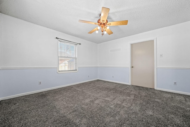 carpeted spare room with ceiling fan and a textured ceiling