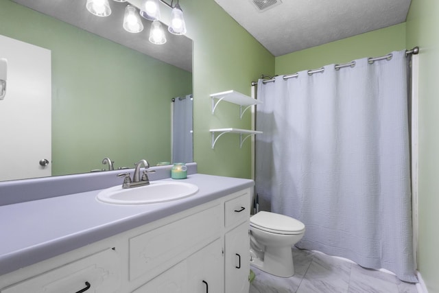 bathroom with vanity, toilet, and a textured ceiling