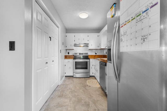 kitchen featuring decorative backsplash, appliances with stainless steel finishes, a textured ceiling, and white cabinetry