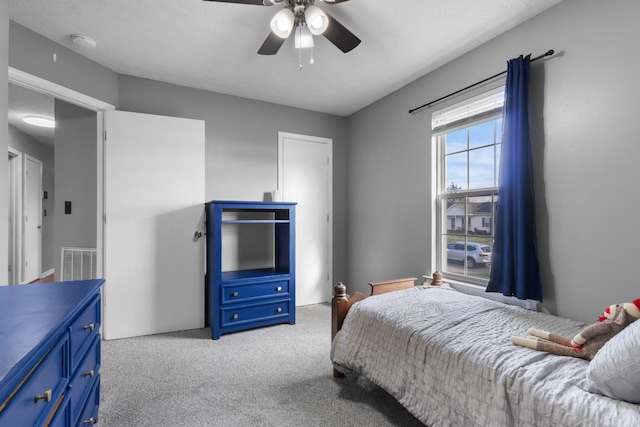 carpeted bedroom featuring ceiling fan