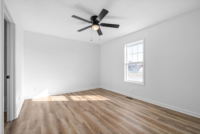 empty room featuring ceiling fan and light hardwood / wood-style floors