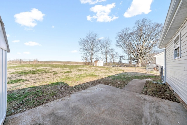 view of yard featuring a storage shed and a patio