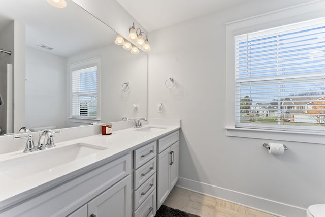 bathroom featuring tile patterned floors, vanity, and toilet