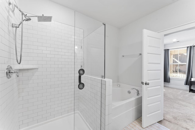 bathroom with shower with separate bathtub