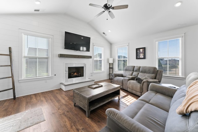 living room featuring dark hardwood / wood-style floors, ceiling fan, and lofted ceiling