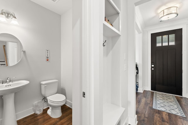 bathroom with hardwood / wood-style floors, toilet, and sink