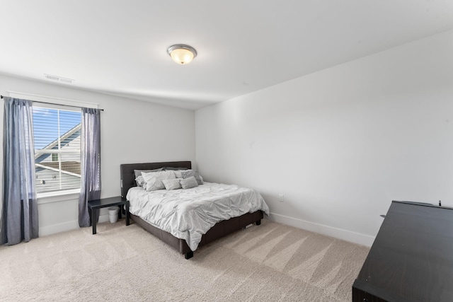 bedroom with light colored carpet