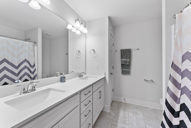 bathroom featuring vanity and toilet