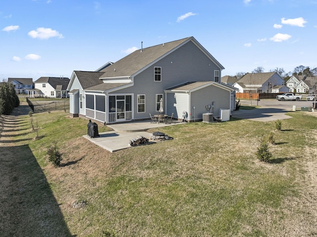 back of property with a yard, central AC unit, a patio area, and a sunroom