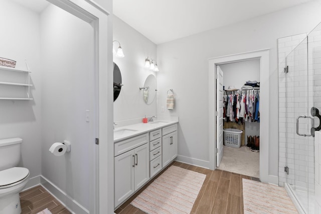 bathroom with vanity, toilet, and walk in shower