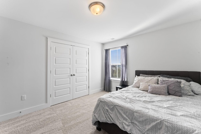 bedroom featuring a closet and light colored carpet