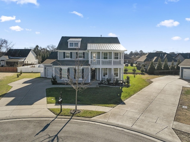 view of front facade with a balcony, a front lawn, a porch, and a garage