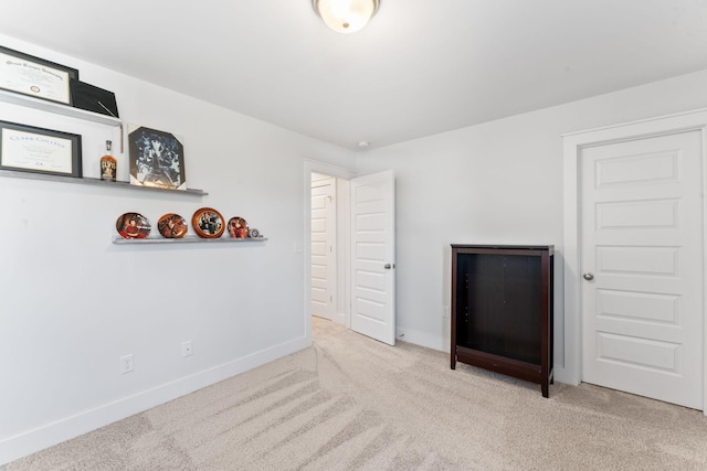 unfurnished room with light carpet