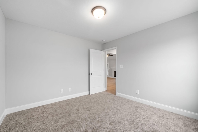 unfurnished room featuring carpet flooring and baseboards