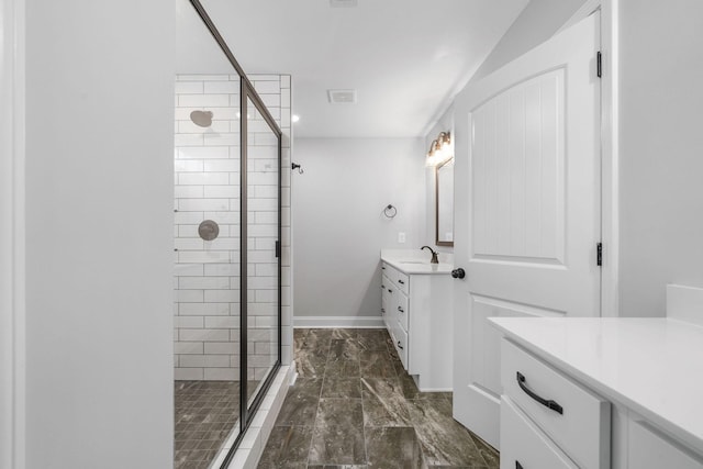 full bathroom with visible vents, a shower stall, vanity, and baseboards