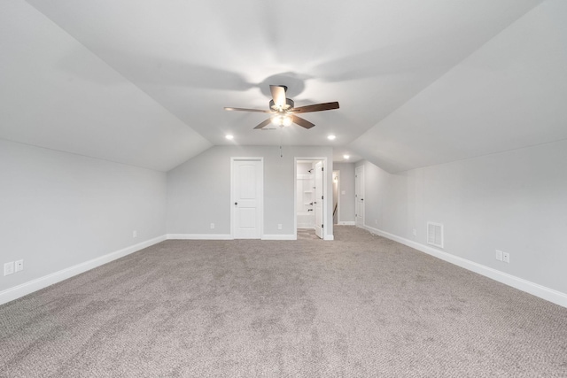 bonus room featuring lofted ceiling, visible vents, and baseboards