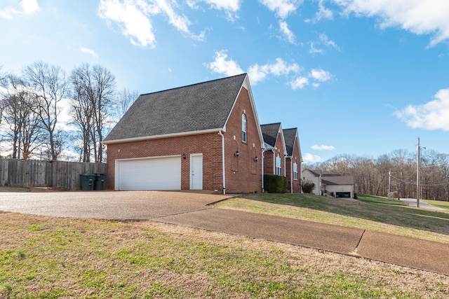 view of home's exterior featuring a lawn and a garage