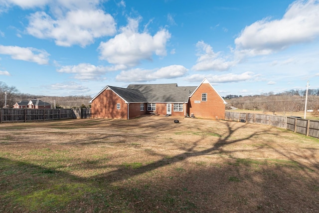 rear view of house featuring a lawn