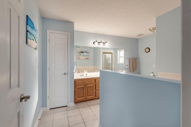 bathroom featuring tile patterned flooring and vanity