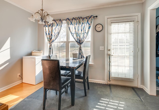 dining space with dark hardwood / wood-style floors, crown molding, and a chandelier