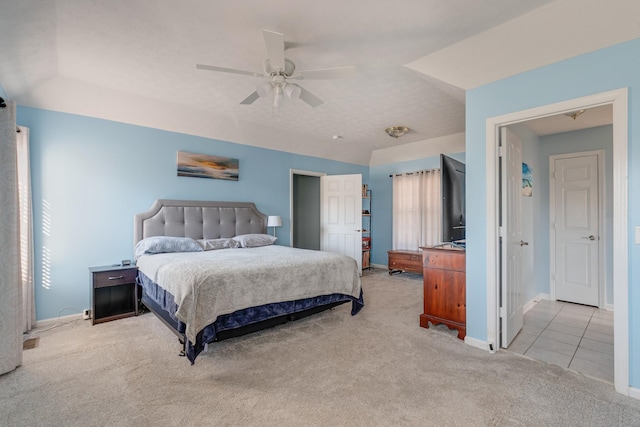 bedroom featuring ceiling fan, light carpet, and vaulted ceiling