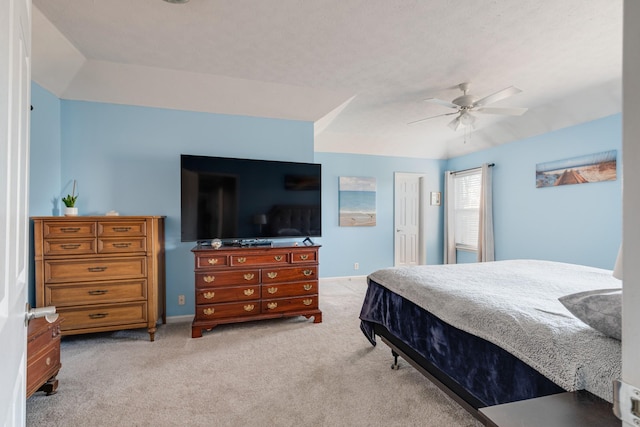 carpeted bedroom with vaulted ceiling and ceiling fan