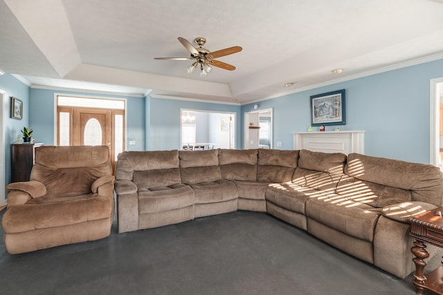 living room with ceiling fan, crown molding, and a tray ceiling