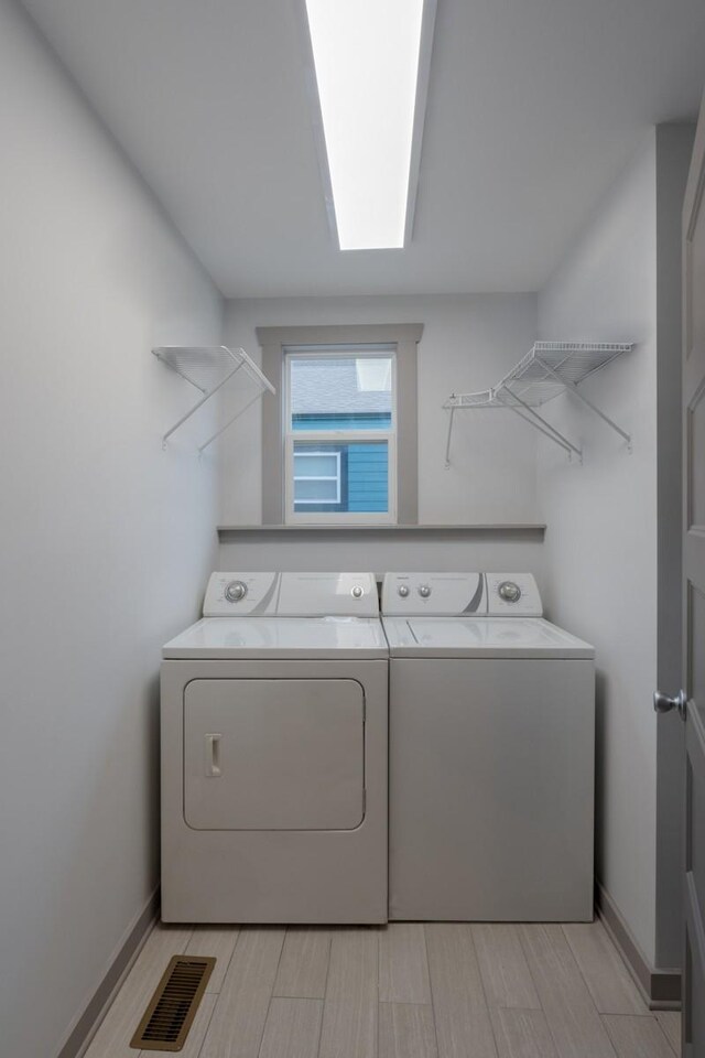 clothes washing area with washer and dryer