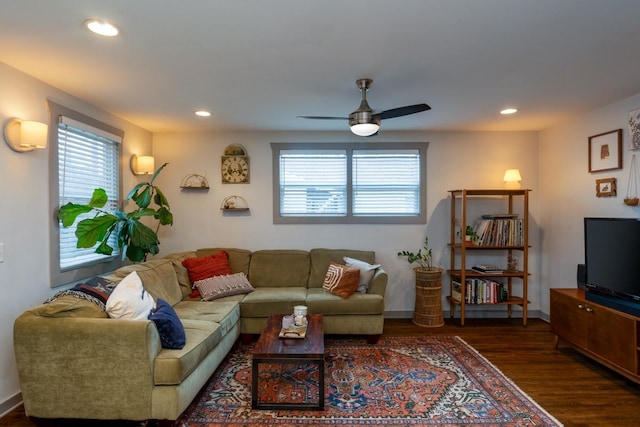 living room featuring ceiling fan and dark hardwood / wood-style flooring